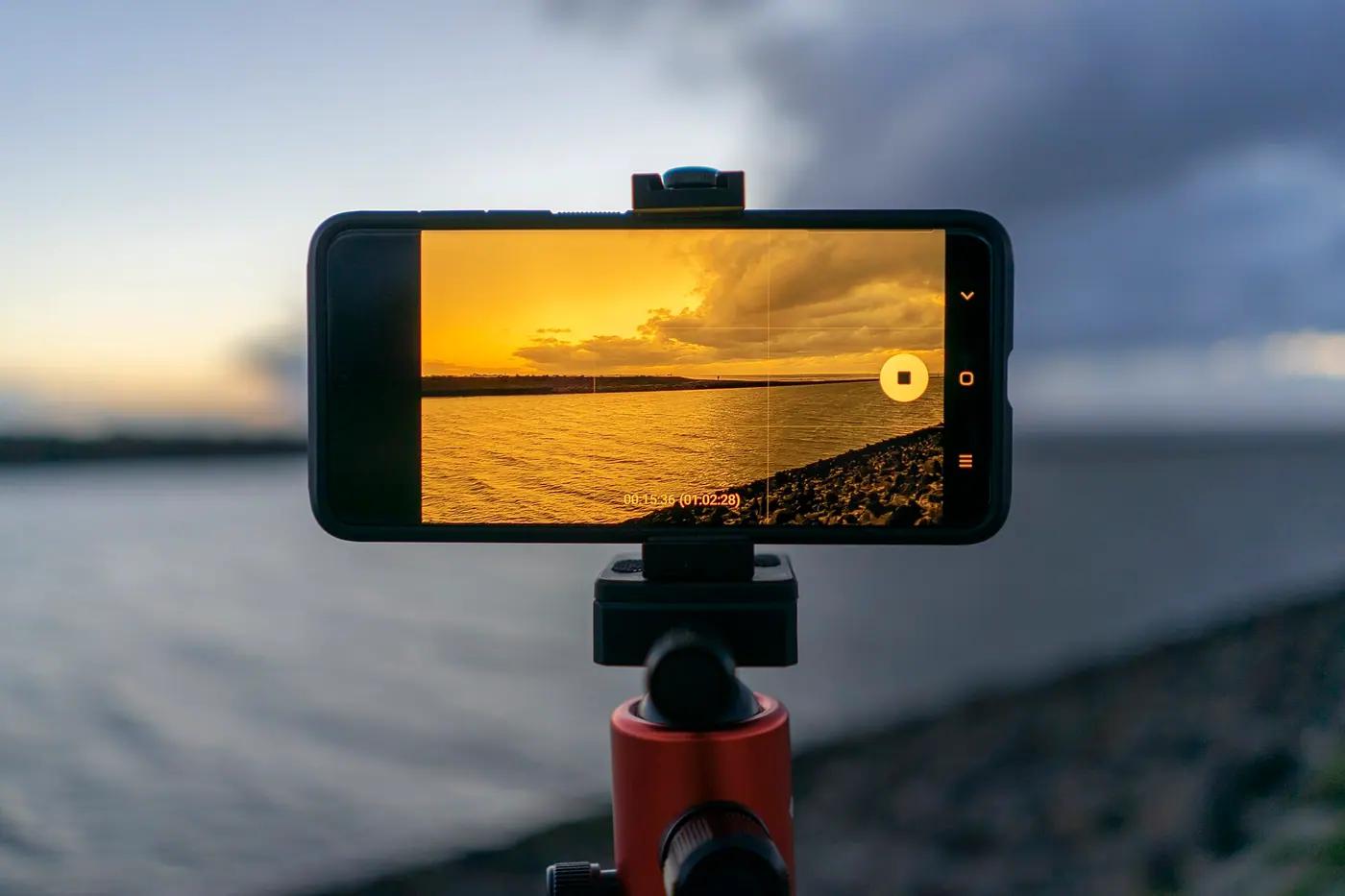 Smartphone on a tripod photographing a sunset