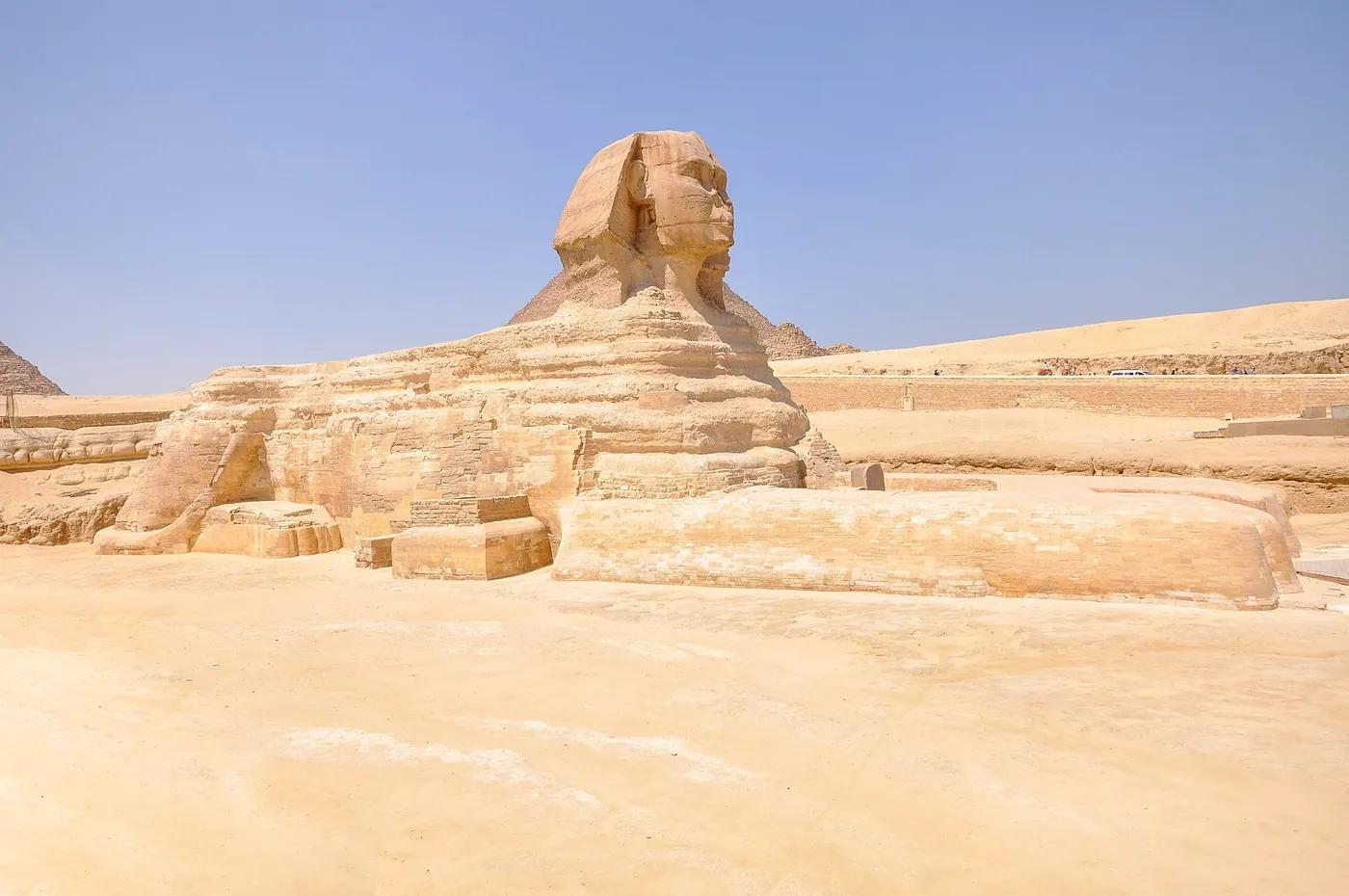 The weathered stone face of the Great Sphinx of Giza, its nose missing